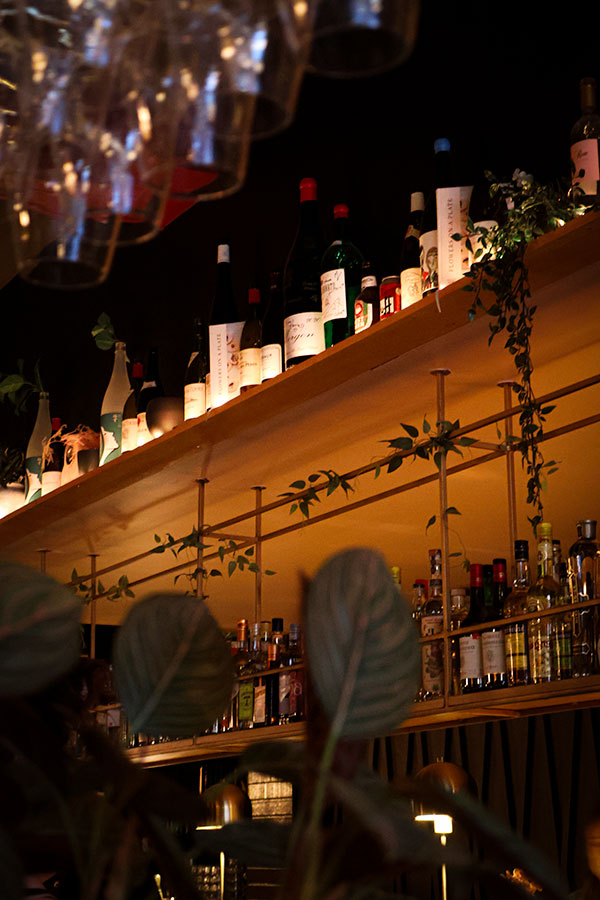 Numerous bottles adorn the bar of the Ratafia wine bar and gourmet desserts