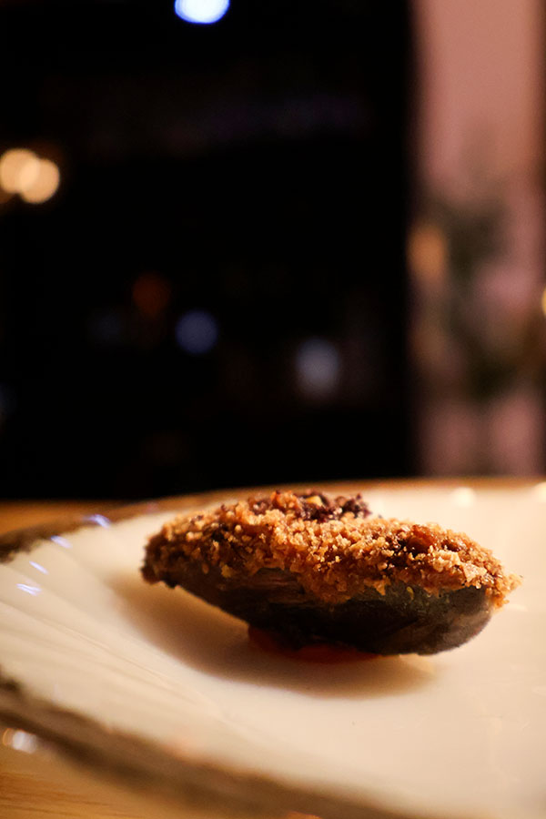 Mussel croquetas on the half shell  with anchovy, bell pepper and kalamata salt at Ratafia wine bar and gourmet desserts