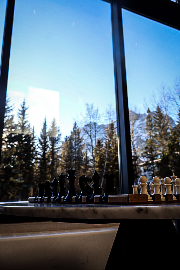 A chess board in the lobby of Pomeroy Kananaskis Mountain Lodge with Mount Kidd in the backgroundPhoto: Normand Boulanger | Gentologie