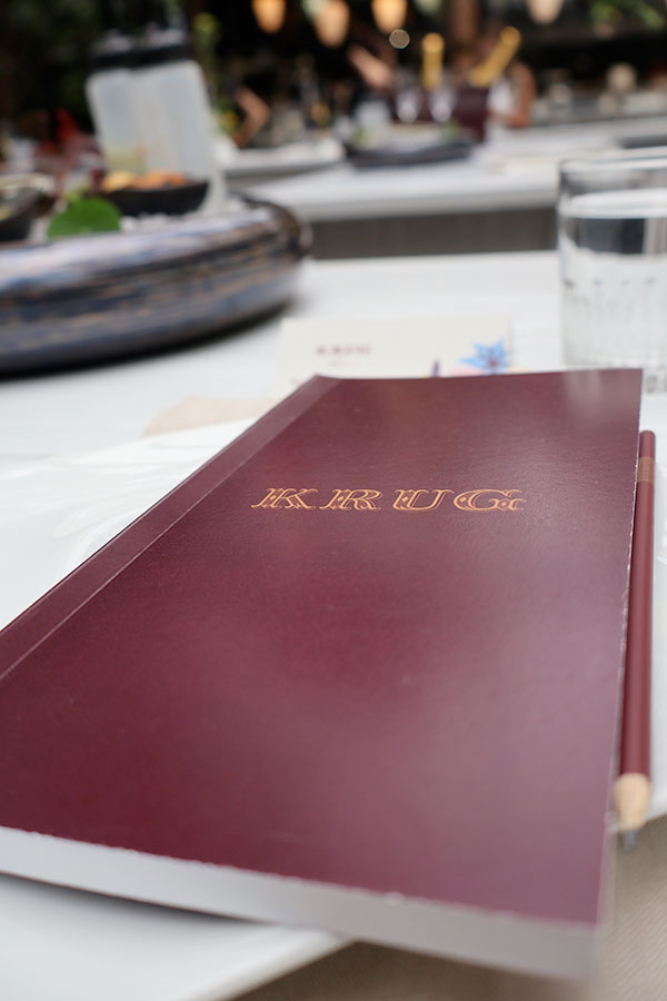 The famous dark cherry notebook handed out at the KRUG Week 2024 presentation at Montréal's Jatoba.