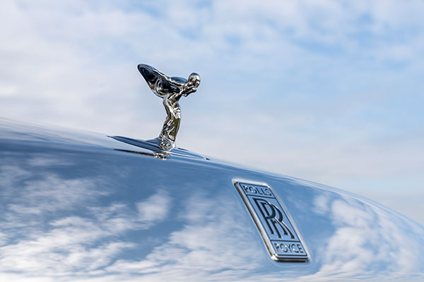 The iconic “Spirit of Ecstasy” logo under a perfect sky