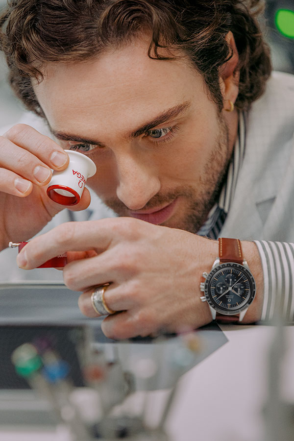 Aaron Taylor-Johnson wearing a Speedmaster First OMEGA in Space with a brown leather strap