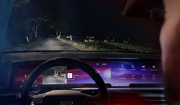 Front-facing view of the pillar-to-pillar screen in the 2025 Cadillac Escalade IQ at night with night vision activated