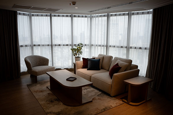 Living room with an armchair and a sofa in one of the suites
