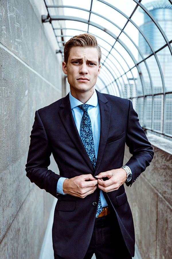 A man buttoning up his suit